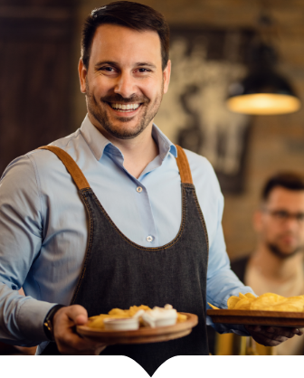 A smiling man holding a plate of food.
