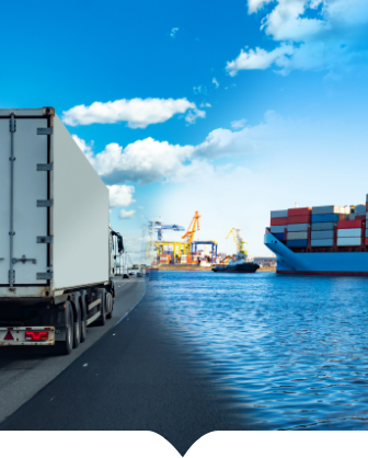 A truck driving down a road next to a body of water.