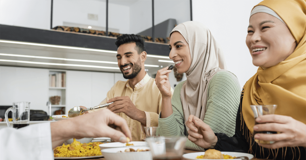 A group of people sitting around a table eating food.