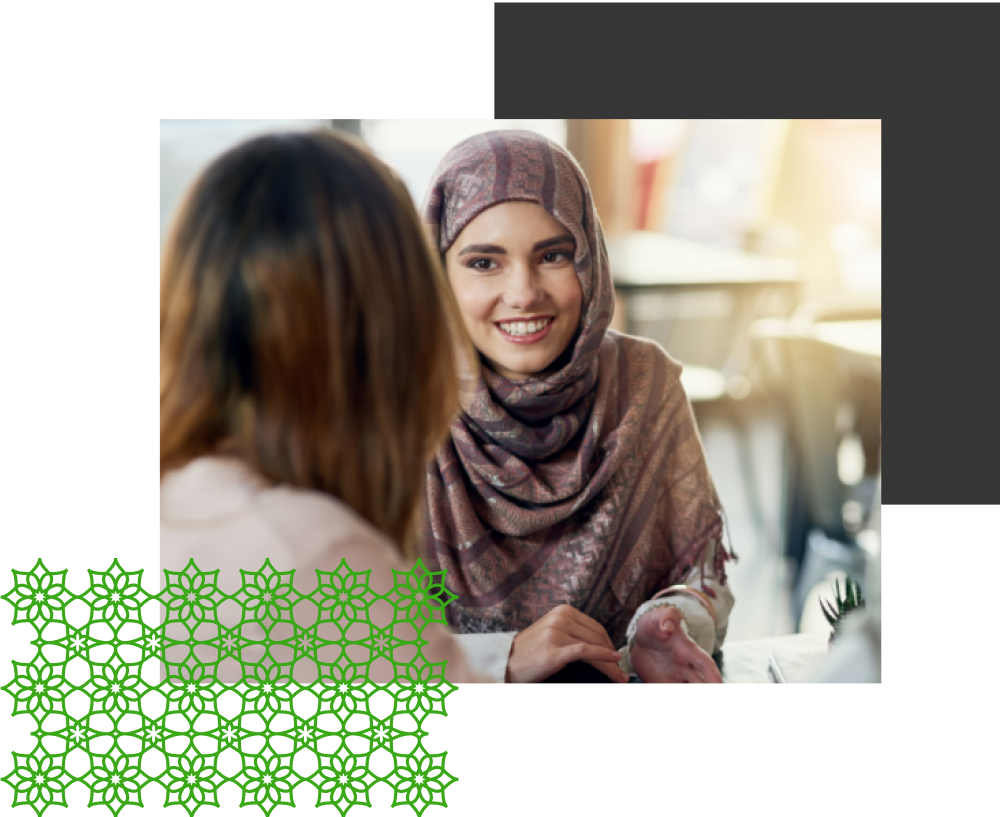 A woman in a headscarf talking to another woman.