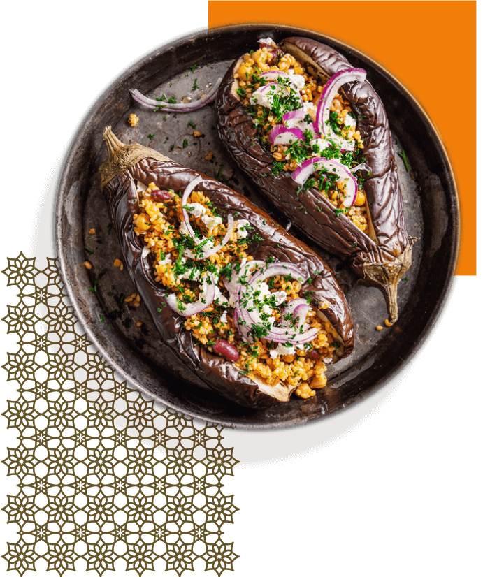 Two stuffed eggplant on a plate with a decorative background.